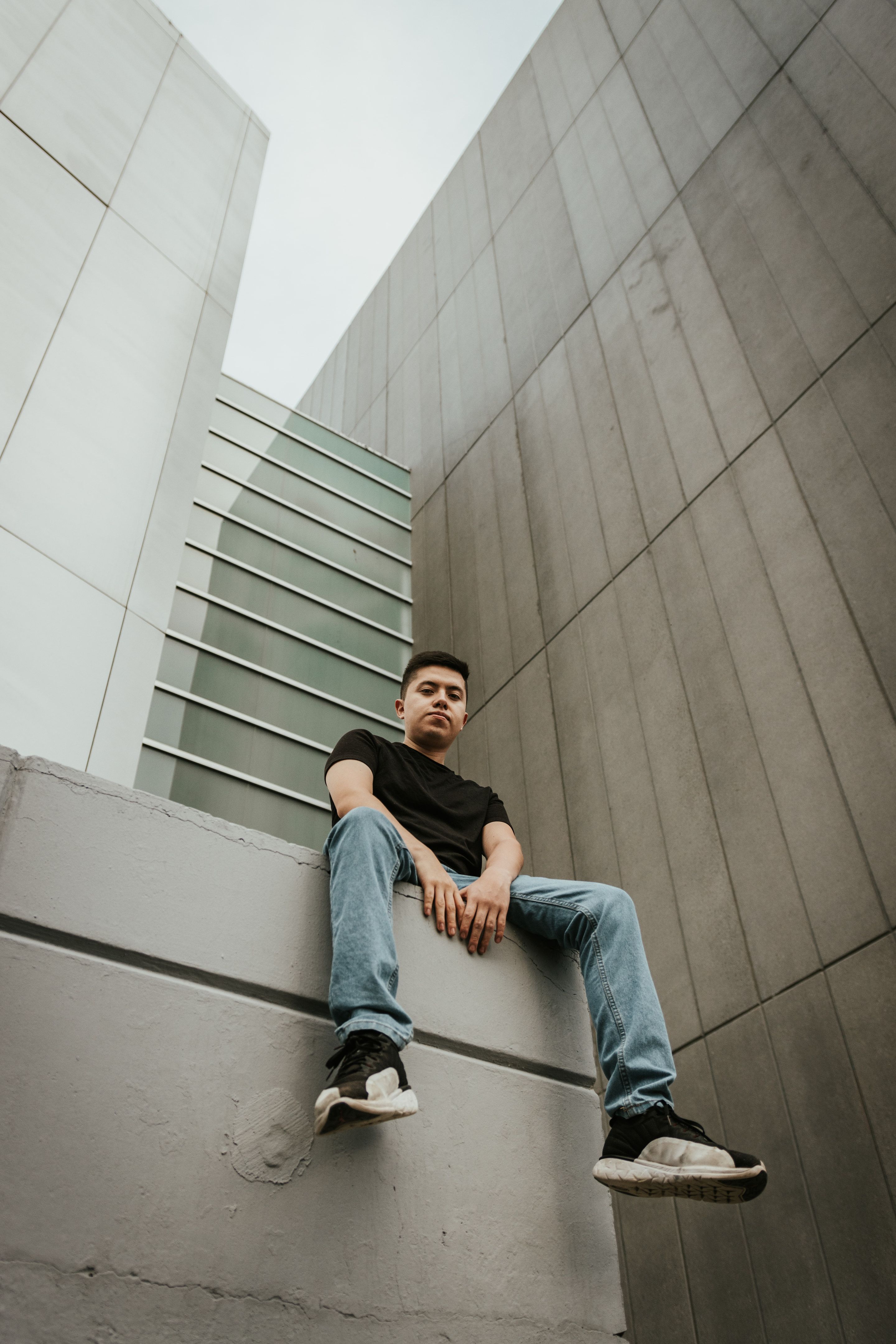 MIKEGAUZZE on a concrete wall under a white facade